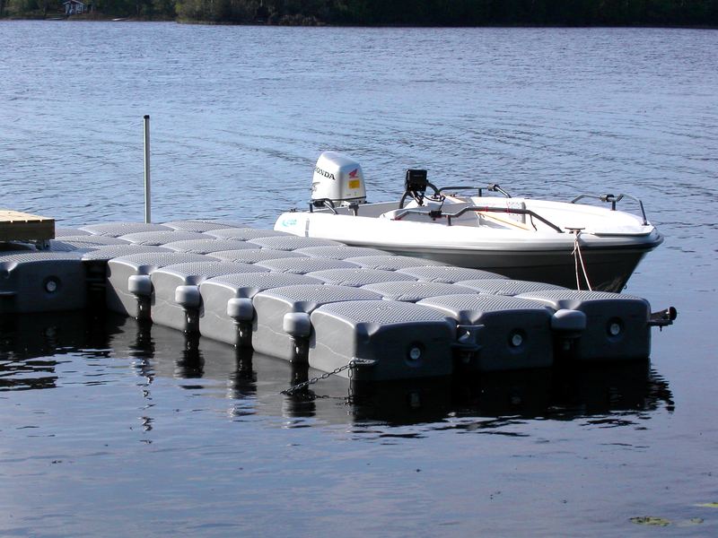 Motorboat moored alongside a floating dock