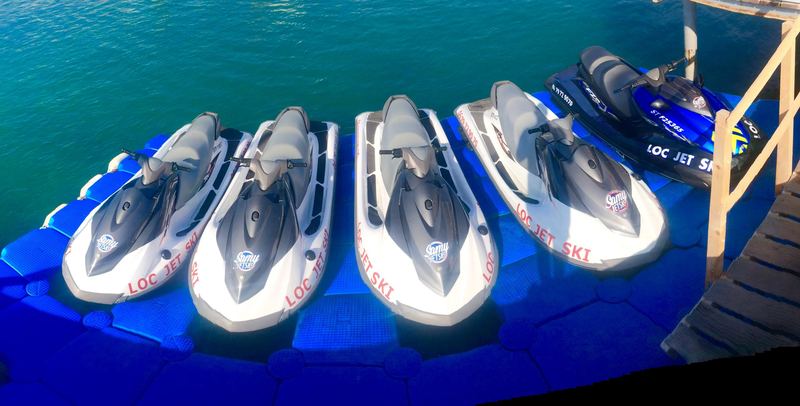 Aerial view of jet skis on blue floating docks