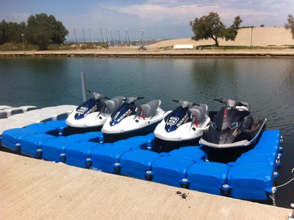 Jet skis parked on a blue Cubisystem floating dock