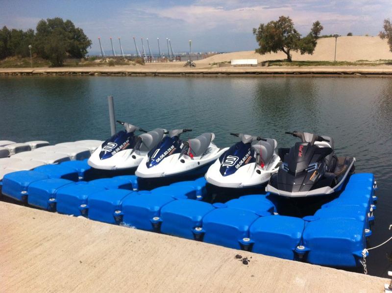 Four jet skis on a blue jet ski dock