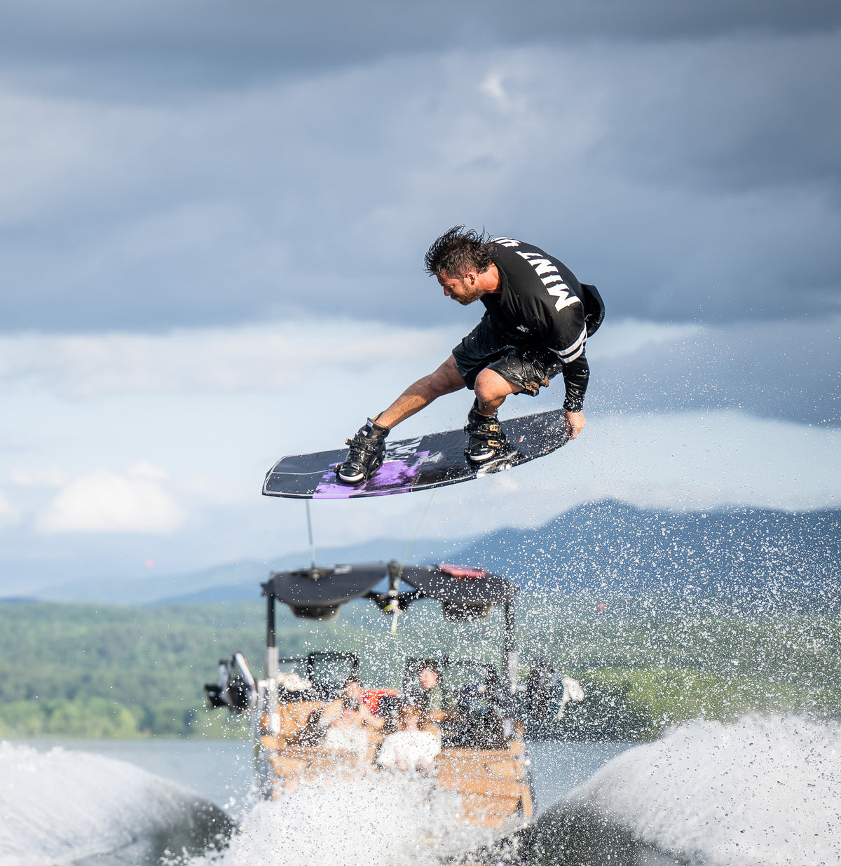 Wakeboarder in the air above a boat wake