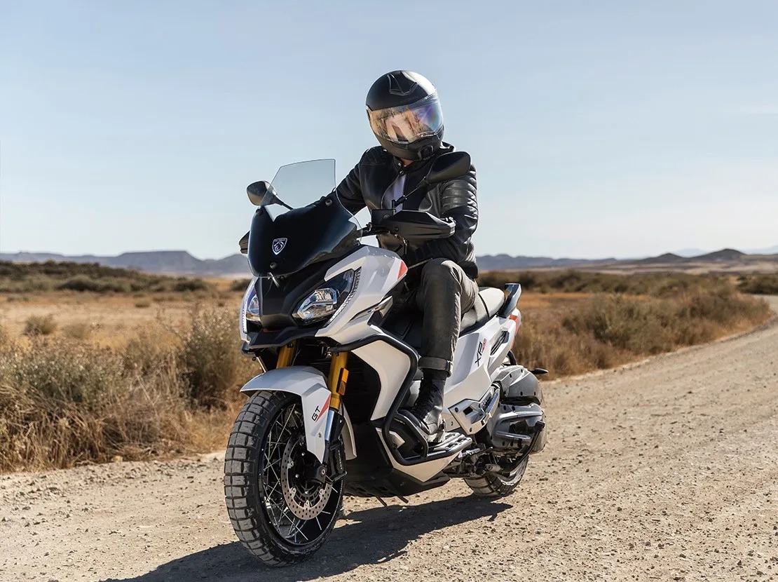 White Peugeot XP400 GT adventure scooter on a desert track