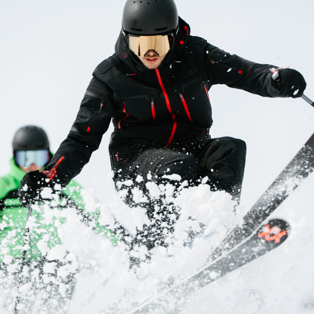 Skier in a black Spyder jacket in deep powder